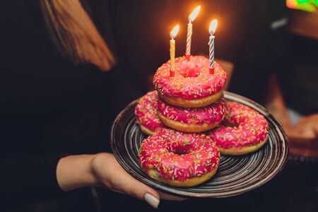 Colorful birthday background with donuts and candles