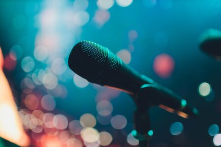 Close up of microphone on stage in audience room blur background
