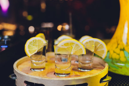 Lemon vodka with ice, vintage wooden background, selective focusの写真素材