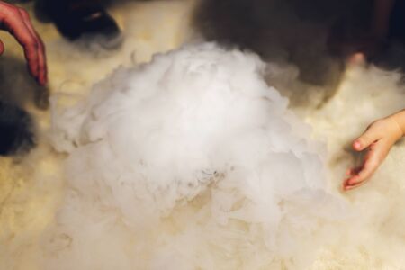 Liquid nitrogen in a glass on a black background