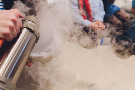 Liquid nitrogen in a glass on a black backgroundの写真素材