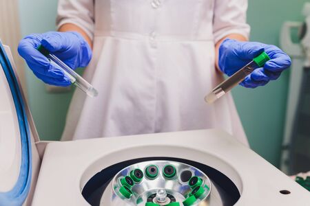 Medical laboratory centrifuge with test tubes with blood.の写真素材