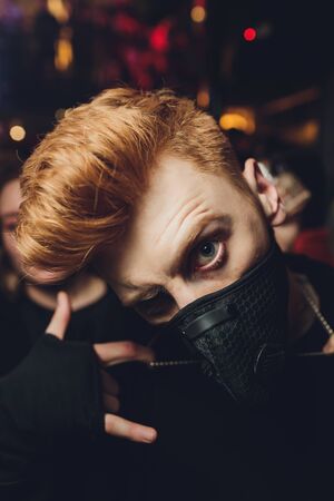 Young boy wears a black safety mask.の写真素材