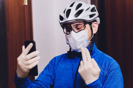 Delivery man holding cardboard boxes in medical rubber gloves and mask. copy space. Fast and free Delivery transport . Online shopping and Express delivery . Quarantine.の写真素材