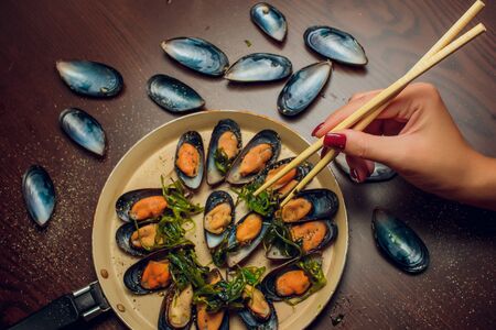 Mussels in the bowl with parsley branchの写真素材