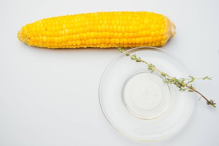fresh corn vegetable with green leaves isolated on white backgroundの写真素材