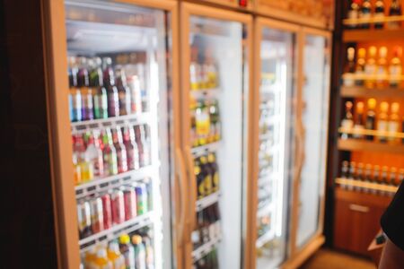 Background Blurred Defocused Beers are cooling in fridge, freezer or refrigerator shelf. Defocused Blurry Night life, Night Club, Bar, Pub, Store or Grocery Background concept imageの写真素材
