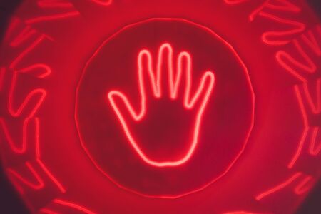 silhouette of hands on light up LED touchscreen table.