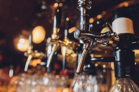 The bar counter with bottles and apparatus for dispensing beer. Apparatus for dispensing beer at the bar. Pub. The bar in the restaurant. Apparatus for dispensing beer in a restaurant.の写真素材