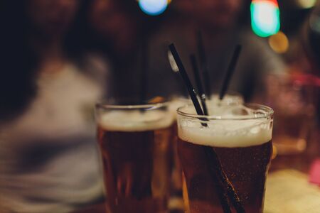 cold light beer glass mug in a pub.の写真素材