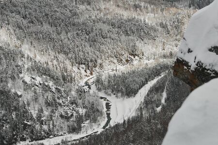 snow coniferous trees in the mountains of the Urals on top of mount aigir