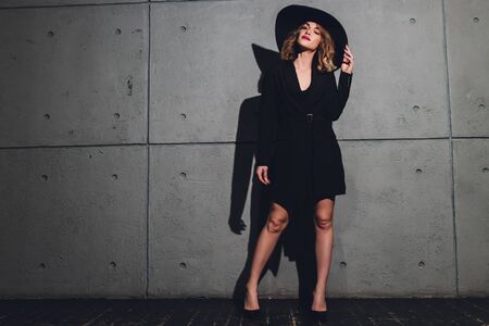 Beautiful woman in hat. Retro fashion. Dark Background.