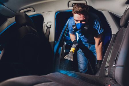 Car interior textile seats chemical cleaning with professionally extraction method. Early spring cleaning or regular clean up.の写真素材