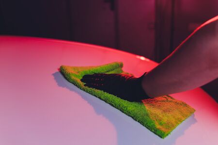 Hand with a microfiber wipe the car polishingの写真素材