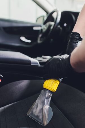 Car interior textile seats chemical cleaning with professionally extraction method. Early spring cleaning or regular clean up.の写真素材