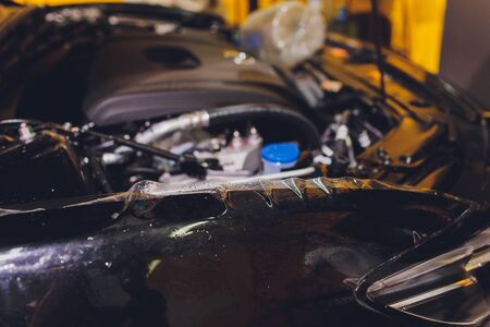 Transparent film, car paint protection, wrapping specialis. Car detailing. Selective focus.の写真素材