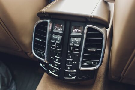 Control panel with digital multi color display and knobs for rear seat passenger in modern prestige...