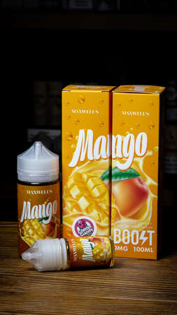 Ufa, Russia, Vape Shop, 3 July, 2019: E-liquid e-juice High vape for electronic cigarette vaping device , on counter in smoke vapor in vape bar in bottles.のeditorial素材