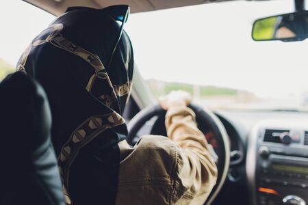 Saudi Woman Driving a Car on the road. Muslim Woman Driver concept.の写真素材