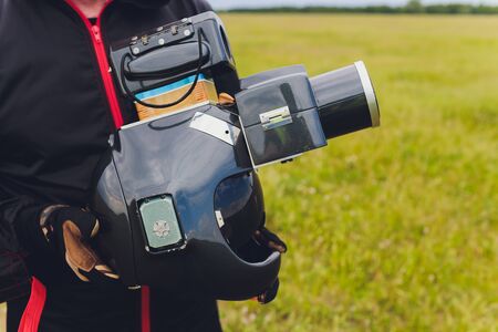 Parachute helmet with an installed DSLR camera in the hands of a skydiver, cameraman and air...
