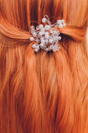 rear closeup view of the shoulders of red haired carrot-top female.の写真素材