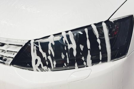 car in foam on carwash, car cleaning.の写真素材