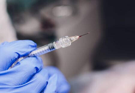 Young woman receiving a injection in her lips, close up.の写真素材