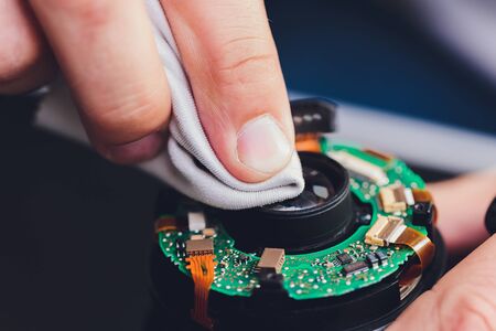 Precision prime optical dslr lens service, adjustment and alignment. Camera lens repair set in photo engineer workplace. Maintenance support of photographic photo camera lens.の写真素材