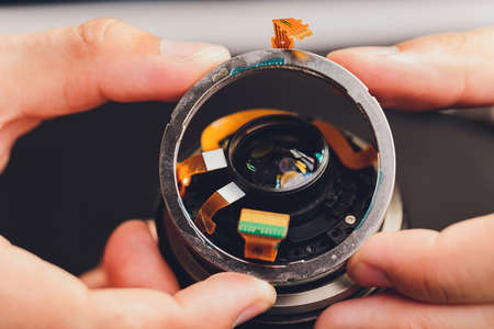 Precision prime optical dslr lens service, adjustment and alignment. Camera lens repair set in photo engineer workplace. Maintenance support of photographic photo camera lensの写真素材