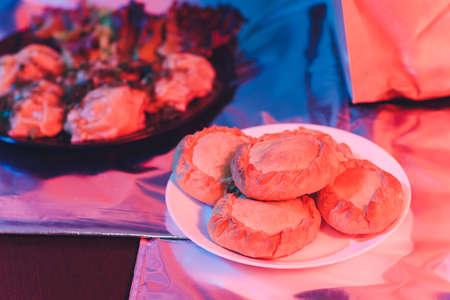 Traditional russian chicken pie kurnik on a plate laying on a table napkin, top view, horizontal.の写真素材