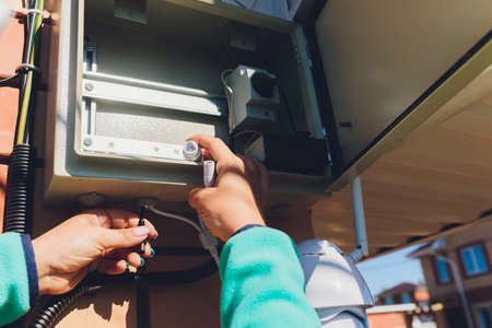 technician female setup cctv camera on wall.の写真素材