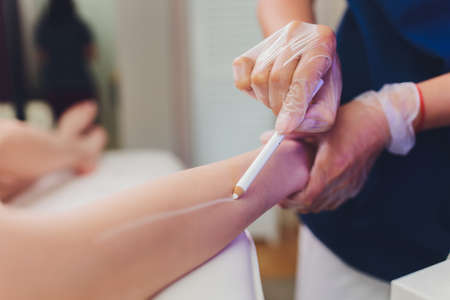 Beautician Giving Epilation Laser Treatment To Woman On Thigh.