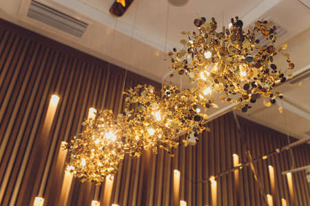 small lamp as stars at big chandelier with many crystals.の写真素材