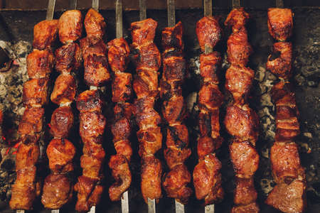 Shish kebab. Pork or lamb meat pieces being fried on a charcoal grill.の写真素材
