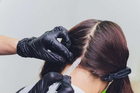 Gas-liquid hair peeling, dandruff cleansing. young woman.の写真素材