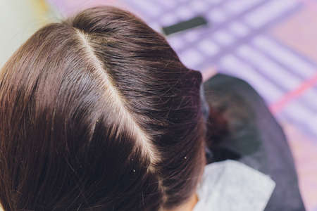 Gas-liquid hair peeling, dandruff cleansing. young woman.の写真素材