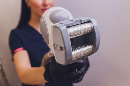 Hardware cosmetology. Vacuum massage. Beautiful young woman.の写真素材