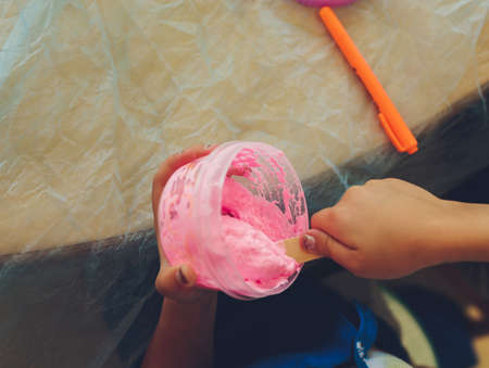 Ingredient for make home made Toy Called Slime, Teenager having fun and being creative homemade slime. Selective focus on Slime.の写真素材