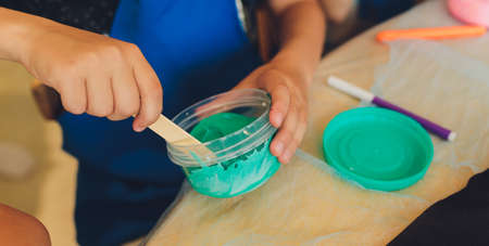 Ingredient for make home made Toy Called Slime, Teenager having fun and being creative homemade slime. Selective focus on Slime.の写真素材