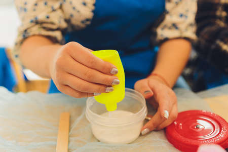 Ingredient for make home made Toy Called Slime, Teenager having fun and being creative homemade slime. Selective focus on Slime.の写真素材