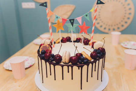 Beautiful tasty birthday cake and gifts on light background.の写真素材