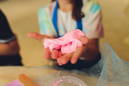 Ingredient for make home made Toy Called Slime, Teenager having fun and being creative homemade slime. Selective focus on Slime.の写真素材