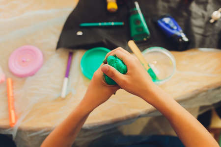 Ingredient for make home made Toy Called Slime, Teenager having fun and being creative homemade slime. Selective focus on Slime.の写真素材