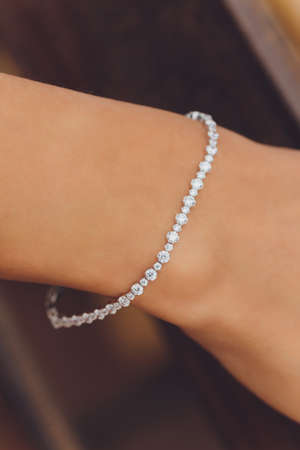 close up of boho styled woman hands with silver jewelry.