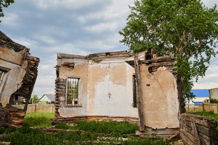 Landscape of ruined buildings at sunset, image of decrepitude or natural disaster.