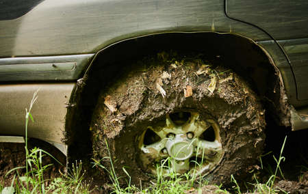 Wheel closeup in a countryside landscape with a muddy road.の写真素材
