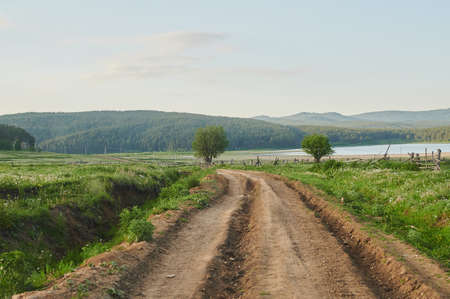 Natural view of green fields in the foreground and mountains of cliffs and hills in the background...
