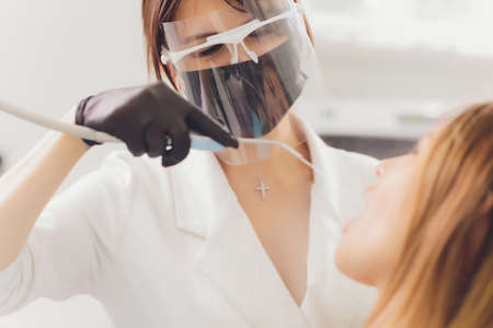 Dentist detects the carious teeth of the patient on the dentists chair.の写真素材