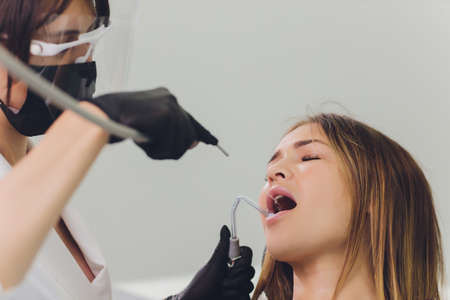 Dentist detects the carious teeth of the patient on the dentists chair.の写真素材