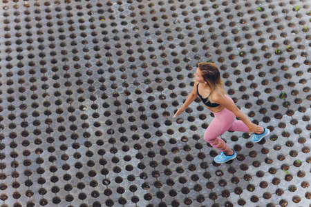 young woman jogging in the park in summer.